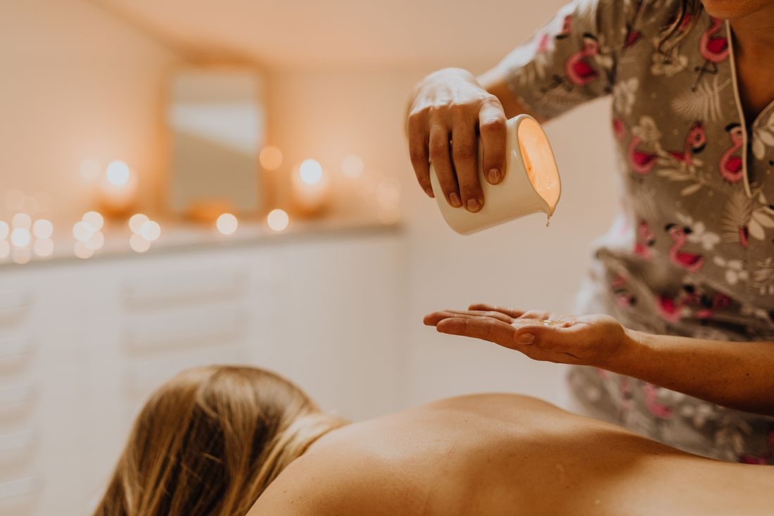 Therapist pouring massage oil